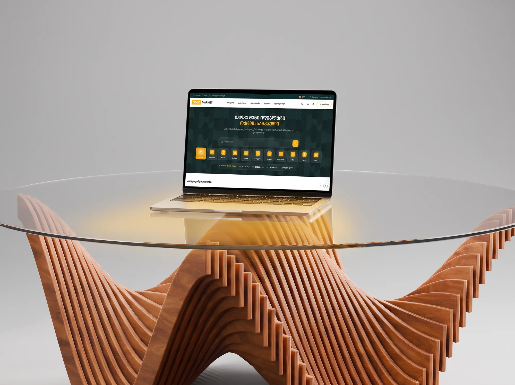 goldmarket.ge on a MacBook on a glass table over a slatted wooden base